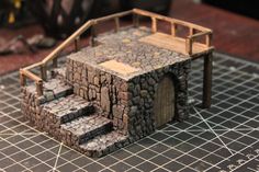 a miniature house made out of rocks and wood