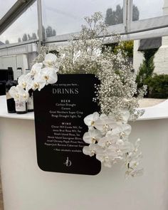 flowers and drinks are on display in the glasshouse for guests to enjoy their meal