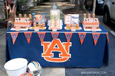 there is a blue table with orange and white decorations on it