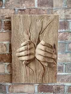 a piece of wood with two hands on it