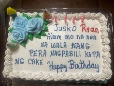 a birthday cake with white frosting and blue flowers