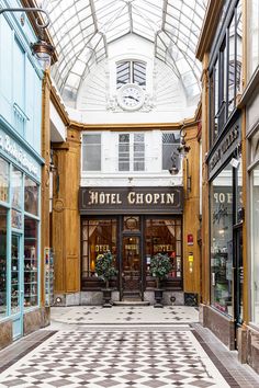 the inside of a hotel lobby with checkered flooring