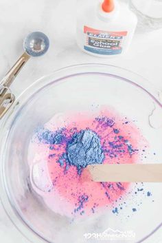 a bowl with blue and pink powder in it