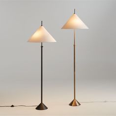 two floor lamps sitting next to each other