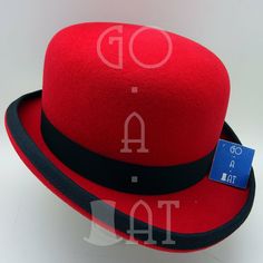 a red hat with a black band around the brim and a blue tag on it