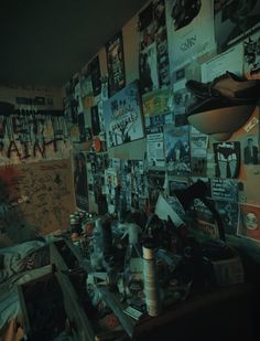 a messy room with posters on the wall and pictures all over the walls in it