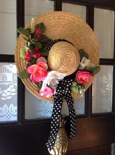 a straw hat decorated with flowers and ribbons