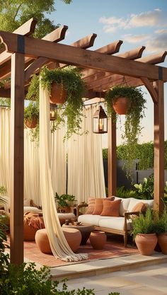 an outdoor living area with couches and potted plants