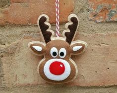 a christmas ornament hanging on the side of a brick wall with a candy cane