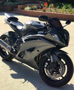 a black motorcycle parked in a parking lot