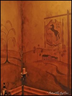 a bathroom with a painting on the wall