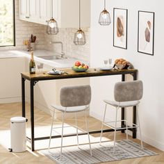 two chairs are sitting at a table with food and drinks in front of the kitchen sink