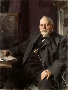 an old photograph of a man sitting at a desk