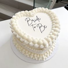 a heart shaped cake with the words bride to be written on it's side