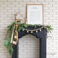 a fireplace decorated with greenery and bells