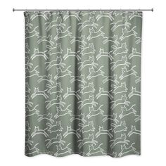 a green shower curtain with white cats on it