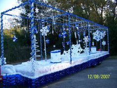 a bed covered in snowflakes and decorations for a winter themed party or event