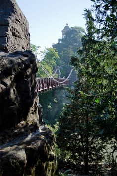 a bridge that is hanging over some rocks