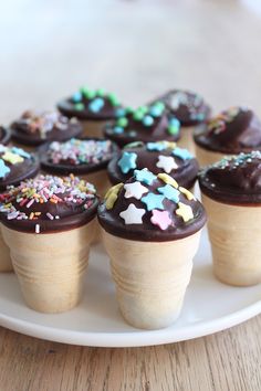 cupcakes with chocolate frosting and sprinkles are on a plate