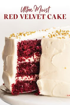 a red velvet cake with white frosting and gold sprinkles