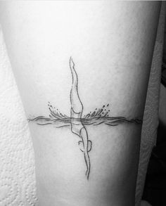 a woman's leg with a bird on it and water splashing from the bottom