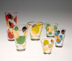 six glasses with different designs on them sitting next to each other