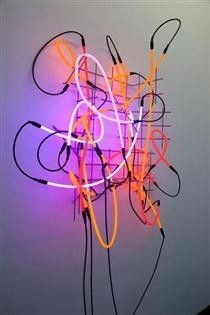 a neon sign that is hanging on the wall in front of a white wall with wires attached to it