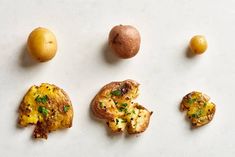 four different types of food are arranged on a white surface, including potatoes and broccoli