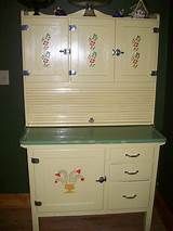 an old fashioned dresser with painted drawers and cupboards on it's top shelf