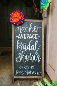 a chalkboard sign that says macho average bridal shower on it next to flowers