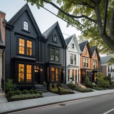 a row of houses on a street with trees and bushes in the foreground, at dusk