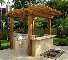 an outdoor bbq and grill area in a backyard