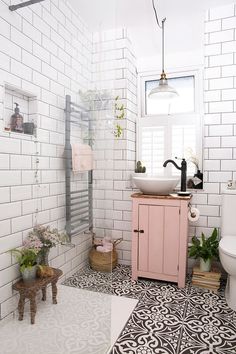 a bathroom with a sink, toilet and window