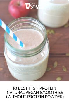 a glass jar filled with smoothie next to an apple and milk bottle on a wooden table