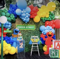 sesame street birthday party with balloon decorations and balloons on the wall, including an elmo character