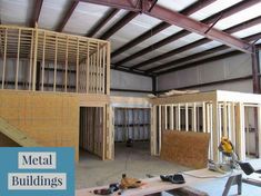 the inside of a building being built with wood framing and metal roofing, along with construction materials