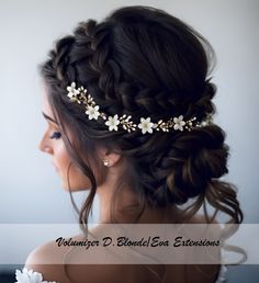 a woman wearing a bridal hair piece with flowers in her hair and braids on her head