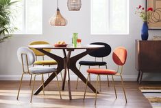 a dining table with four chairs around it