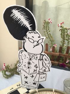 a paper cut out of a man holding a hairbrush on top of a table