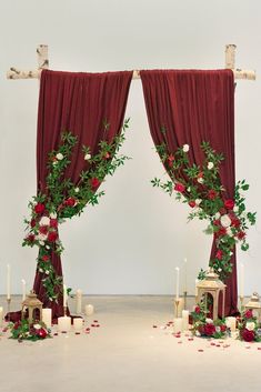 two red drapes decorated with roses and greenery