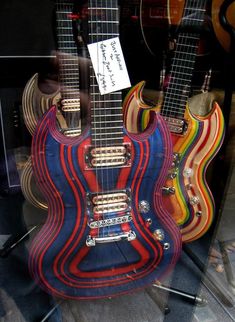 guitars are on display in a store window