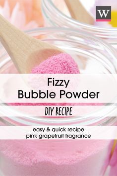 a pink powder in a glass jar with a wooden spoon on it and the words fizzy bubble powder diy recipe