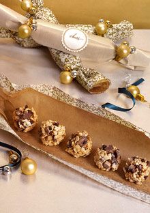 some cookies are sitting on a table next to a wine bottle and other holiday decorations