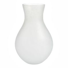 a white vase sitting on top of a table