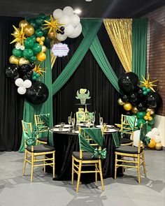 a green and gold party setup with balloons