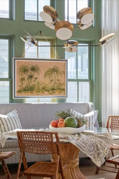 a living room filled with furniture and lots of windows