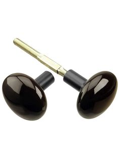 two black and gold ear plugs on a white background