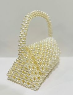 beautiful white pearl purse to elevate your style. fits your phone Cream Evening Bag With Pearl Handle, Elegant Handheld Beaded Evening Bag, Elegant Pearl White Beaded Clutch, Pearl Evening Bag With Pearl Handle, Cream Evening Bag With Pearl Handle For Gift, Cream Evening Bag With Pearl Handle As Gift, Pearl Embellished Clutch, Pearl White Beaded Shoulder Bag For Party, Elegant Pearl White Clutch With Pearl Embroidery