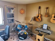 a room with guitars and musical instruments on the wall