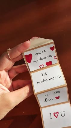 someone is holding three cards with hearts on them and the words you're my favorite you make me i love you